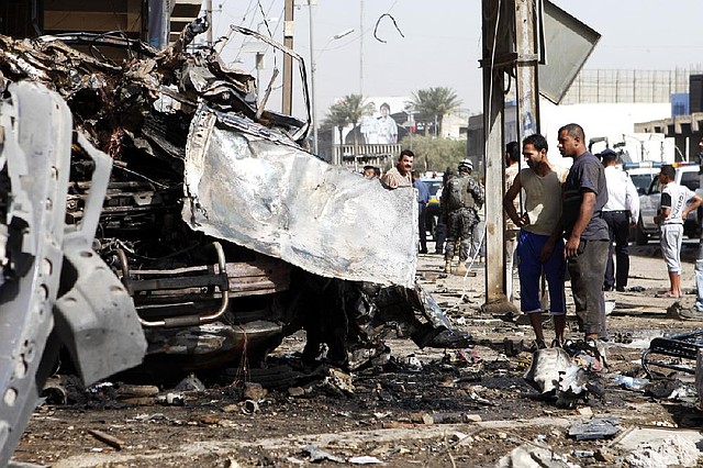 Authorities investigate a car bombing Wednesday in a Baghdad neighborhood. 