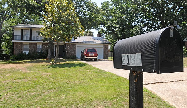 Trees shade the former home of Bernice Dunaway at 2135 N. Juneway Terrace in Fayetteville. Dunaway’s house, which was purchased and renovated by neighbors Tracy Hutchens and Rebecca Hutchens after her death in 2009, is the subject of a lawsuit.