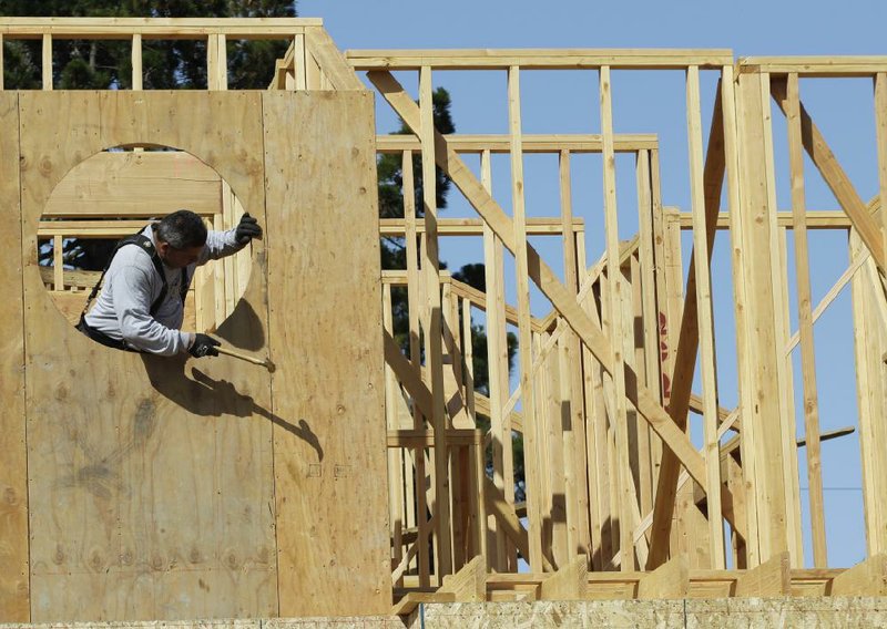 Mario Sanchez works on the frame of a house being built in Palo Alto, Calif., on Monday. Confidence among U.S. builders rose to a five-year high in June, according to the National Association of Home Builders/Wells Fargo confidence index. 