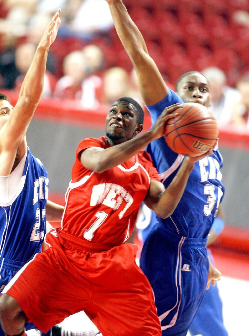 Nate Griffin of Benton tries to get to the basket while being defended by Austin Brown (left) of Heber Springs and Warren Boyd of Marion during the All-Star boys basketball game in Bud Walton Arena in Fayetteville on Wednesday, June 20, 2012.
