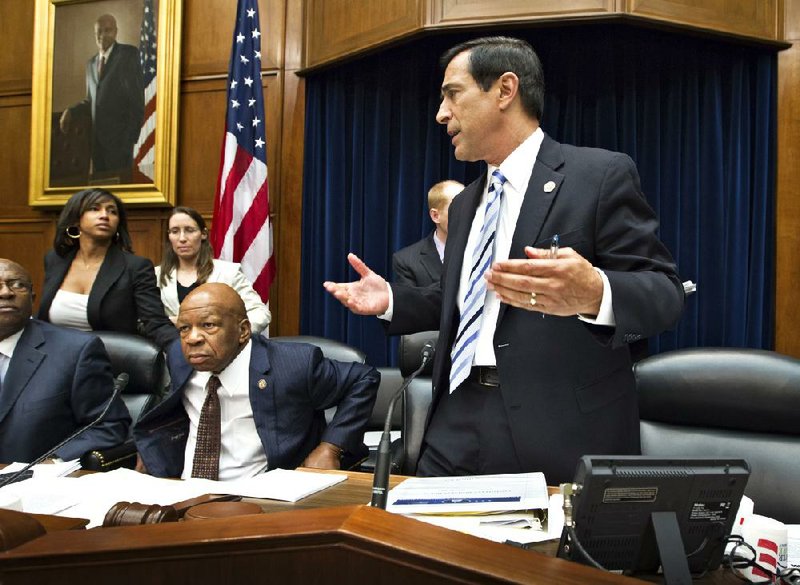 Chairman Darrell Issa adjourns a meeting of the House Oversight and Government Reform Committee on Wednesday after the panel voted to recommend holding Attorney General Eric Holder in contempt of Congress. The committee’s ranking Democrat, Elijah Cummings, is at left. 