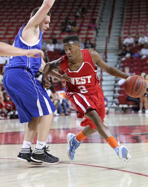 DuShaun Rice of Fort Smith Southside, right, drives toward the basket Wednesday during the boys’ All-Star game.