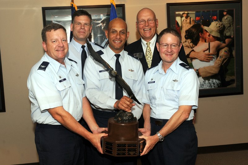Team Little Rock and community leaders were presented the Abilene Trophy, Air Mobility Command’s (AMC) Community Support Award, by the Abilene, Texas, Chamber of Commerce at the June 20 Little Rock AFB Community Council Meeting. Pictured from left are Col. Archie Frye, 22nd Air Force Detachment 1 commander; Col. Scott Brewer, 314th Airlift Wing Commander, Col. Brian Robinson, 19th Airlift Wing commander, Larry Biernacki, LRAFB Community Council president, and Col. Steven Eggensperger, 189th Airlift Wing commander.