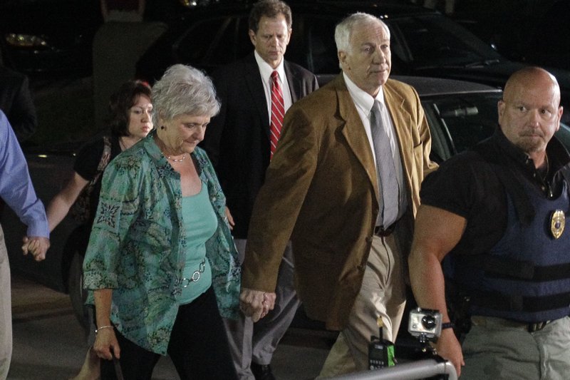 Former Penn State University assistant football coach Jerry Sandusky, right center, arrives with his wife Dottie, left center, at the Centre County Courthouse in Bellefonte, Pa., Friday, June 22, 2012. 