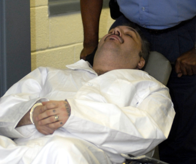 FILE - An Arkansas Department of Correction officer pushes death-row inmate Jack Harold Jones Jr., into a room for Jones' clemency hearing, Friday, Sept. 7, 2007 at the department's Varner Unit in Varner, Ark.