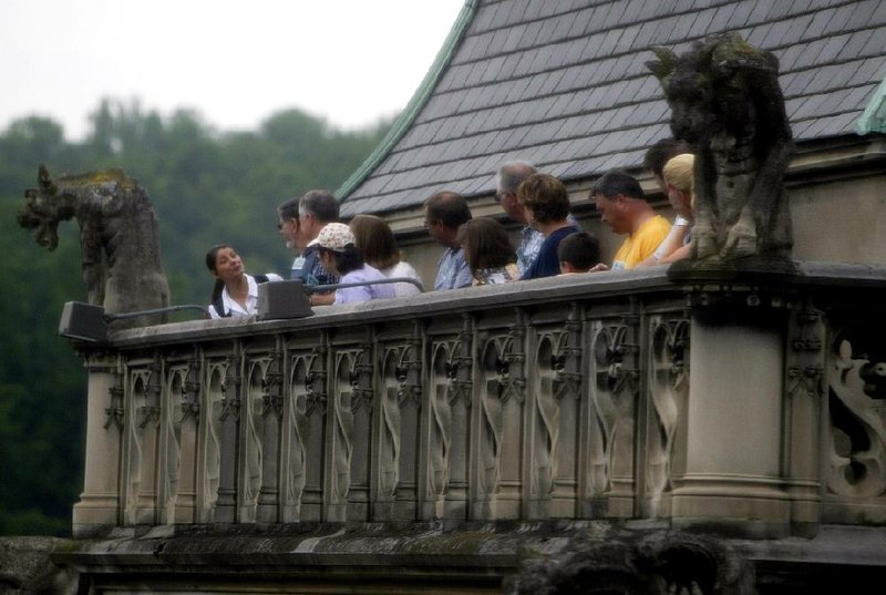 Visitors to the Biltmore House look out from to roof outside George Vanderbilt's Observatory at the estate in Asheville, N.C., Wednesday July 6, 2005. Seventy-five years after it was first opened to the public, George W. Vanderbilt's grand Biltmore House is showing off a new side. Ten rooms on the house's fourth floor _ including several that housed the servants who kept the 250-room house running _ have been restored and opened to the public for the first time. (AP Photo/Chuck Burton)