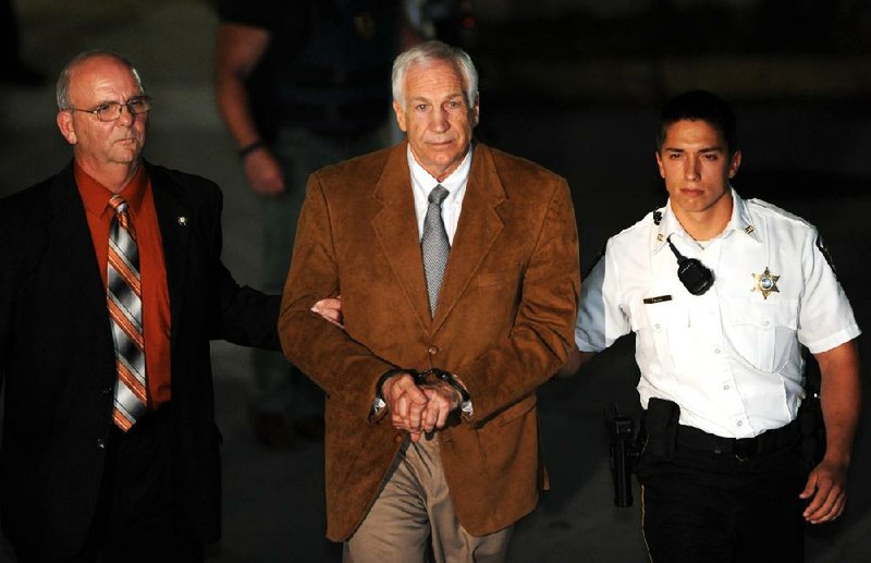 Former Penn State assistant football coach Jerry Sandusky (center) is escorted from the Centre County (Pa.) Courthouse on Friday after being found guilty on 45 of 48 counts of sexually assaulting 10 boys over a 15-year period. The case led to the firing of longtime coach Joe Paterno. 