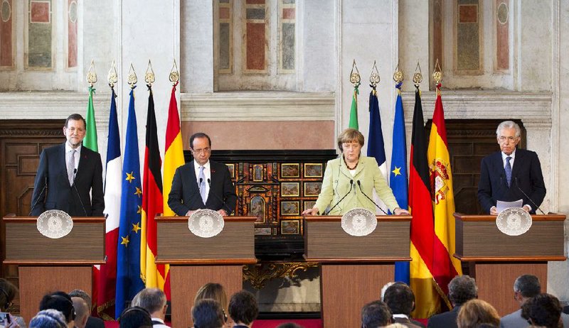 Spanish Premier Mariano Rajoy, (from left) French President Francois Hollande, German Chancellor Angela Merkel and Italian Premier Mario Monti talk to reporters after the leaders met Friday in Rome. 