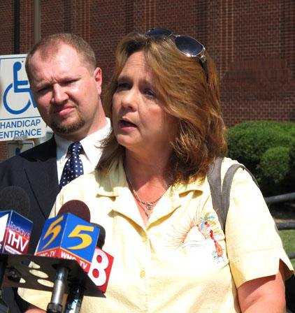 Pam Hicks talks to media outside the Crittenden County Courthouse on Friday, June 22, 2012 in Marion, Ark. Hicks is suing the city of West Memphis and the West Memphis police department, demanding to see the belongings her son, Steve Branch, had with him the day he was killed 19 years ago. Branch is one of three Arkansas Cub Scouts brutally murdered 19 years ago. Also pictured  is law student Danny Owens. (AP Photo/Adrian Sainz)