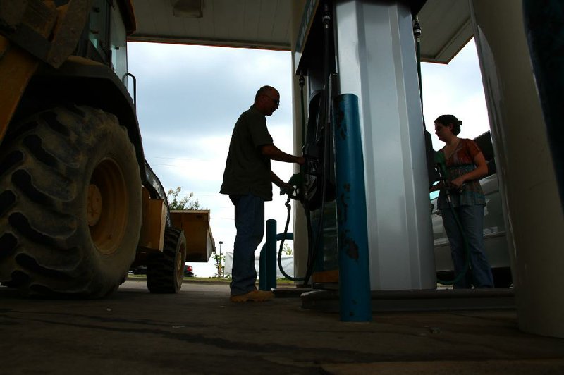 Customers pump fuel Friday afternoon at the Valero station at 925 Fair Park Blvd. in Little Rock. 