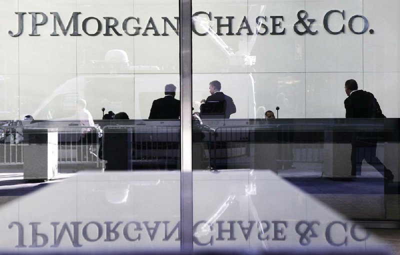 JPMorgan Chase, with headquarters in New York, was among the banks that saw their credit ratings lowered Thursday by Moody’s Investors Service. JPMorgan’s shares gained 1.3 percent Friday. 