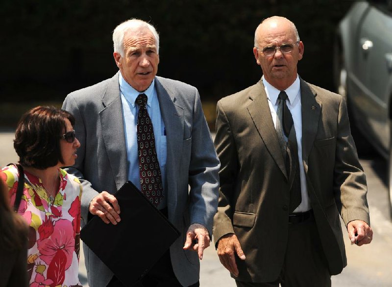 Former Penn State University assistant football coach Jerry Sandusky leaves the courthouse with Centre County Sheriff Denny Nau, right, in Bellefonte, Pa., Thursday, June 21, 2012.  Jurors in Sandusky's child sexual abuse case began deliberations Thursday after prosecutors described him as a serial molester who groomed his victims, while his defense lawyer said the former Penn State assistant football coach was being victimized by an overzealous prosecution and greedy accusers. (AP Photo/Centre Daily Times, Nabil K. Mark)