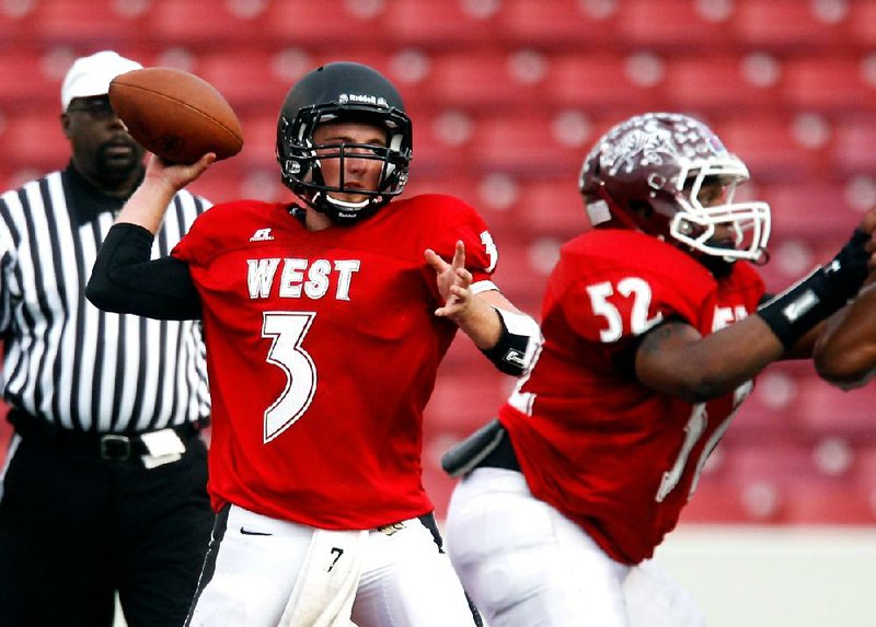 Dallas Hardison of Bentonville throws a pass during the All-Star football game at Donald W. Reynolds Razorback Stadium in Fayetteville on Thursday, June 21, 2012.