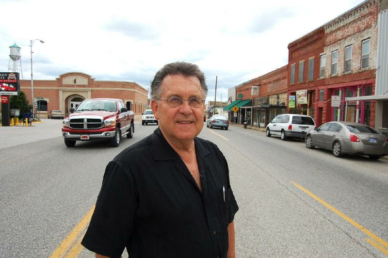 Arkansas Democrat-Gazette/BILL BOWDEN

Green Forest Mayor Charlie Reese stands in the center lane of U.S. 62. Widening the highway to five lanes through the city would result in the destruction of historic buildings on the right, he said. (It's his left, though).

6/21/12