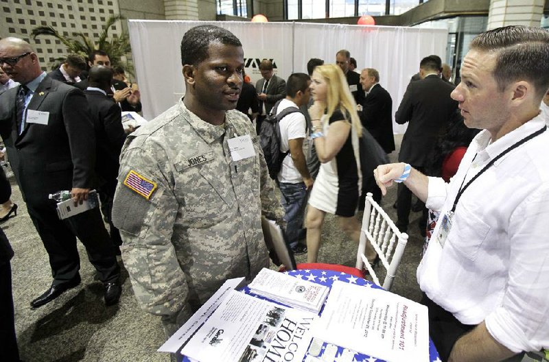 Matthew Desrosiers, right, of the Manhattan Vet Center, confers with Eric Jones, of Clevelend, during the Hiring Our Heroes job fair, part of the second annual VOWS Conference on Veteran Joblessness in New York,  Thursday, June 21, 2012. The sluggish job market is weighing on the U.S. economy three years after the Great Recession ended and it doesn't look to be getting much better any time soon. (AP Photo/Richard Drew)