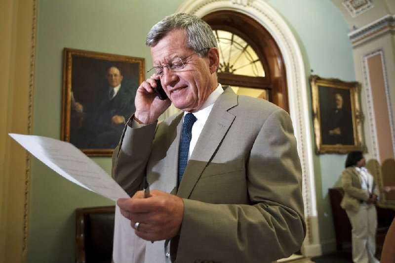 Max Baucus, D-Mont., a member of the Senate agriculture committee, takes a phone call Thursday after the Senate passed a farm bill with bipartisan support. 