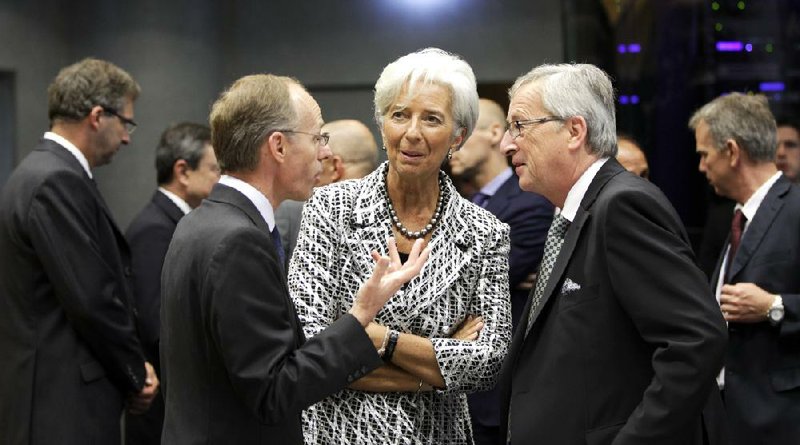 Christine Lagarde, director of the International Monetary Fund, speaks with Luxembourg Prime Minister Jean-Claude Juncker (right) and Luxembourg’s Economy Minister Luc Frieden during a meeting of eurozone finance ministers Thursday in Luxembourg. 