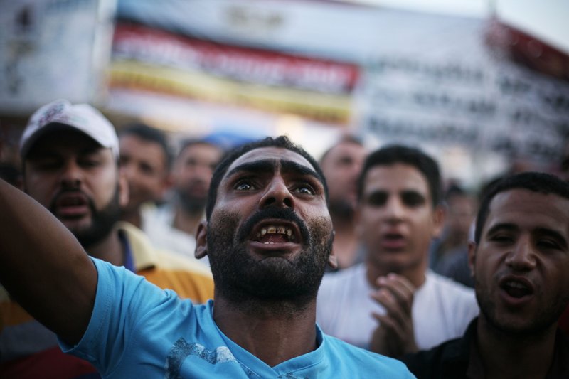 Egyptian protesters shout slogans in Tahrir Square as the country awaits the outcome of a presidential runoff vote in Cairo, Egypt, Saturday, June 23, 2012. Tens of thousands of supporters of the Muslim Brotherhood have rallied in the capital's Tahrir Square in a show of force backing candidate Mohammed Morsi, who has warned against manipulating results in a vote that he says he has won.