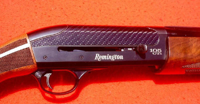 Arkansas Democrat-Gazette/BRYAN HENDRICKS
The Remington 105 CTi has a distinctive profile defined by the lack of an ejection port on the side of the receiver. A carbon fiber hood over the titanium receiver displays a holographic checkerboard/basket weave pattern. The trigger group comes out by removing the two drift pins behind the Remington logo.
