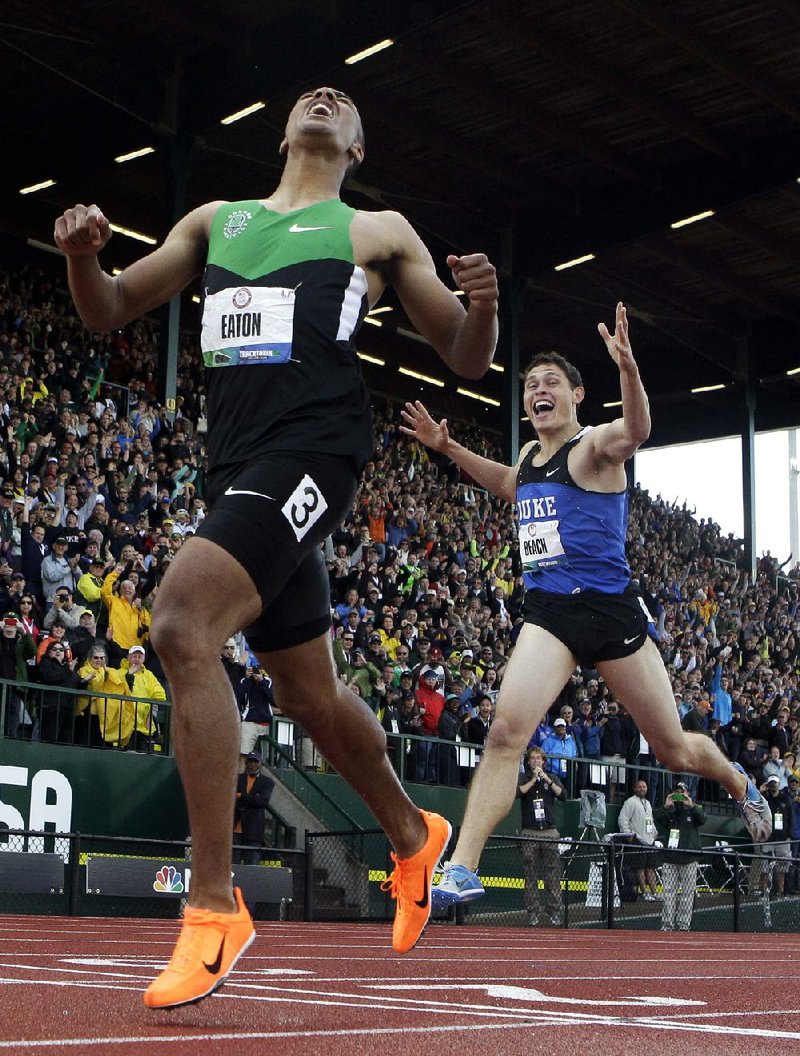 Ashton Eaton and Curtis Beach react after the 1500m during the decathlon competition at the U.S. Olympic Track and Field Trials Saturday, June 23, 2012, in Eugene, Ore. Eaton finished the decathlon with a new world record. (AP Photo/Matt Slocum)