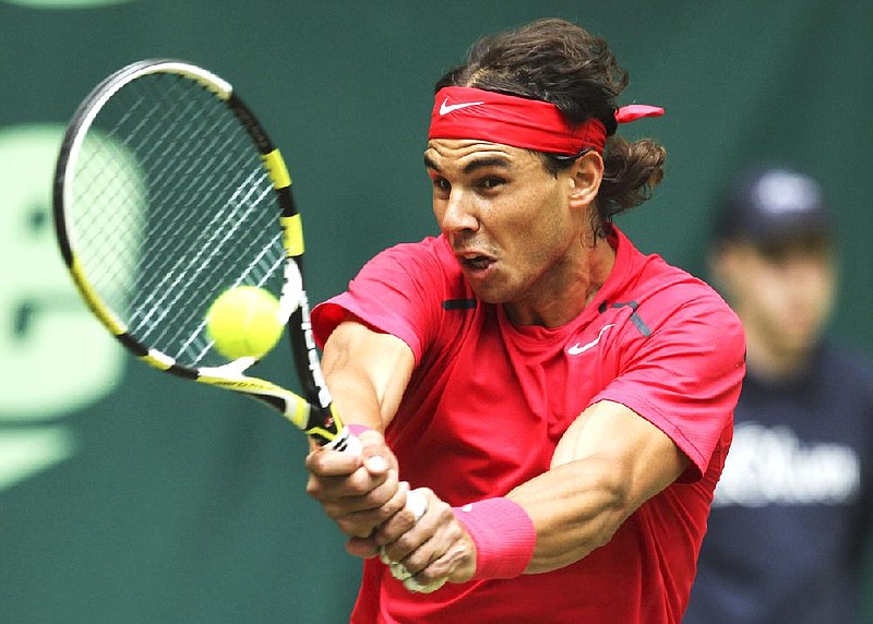 Spain's Rafael Nadal  returns a ball during his match against Lukas Lacko from Slovakia at the  Gerry Weber Open, ATP tennis tournament in Halle, Germany, Thursday June 14, 2012. Nadal advanced to the quarterfinals and will face German Philipp Kohlschreiber.  (AP Photo/dapd/Joerg Sarbach)