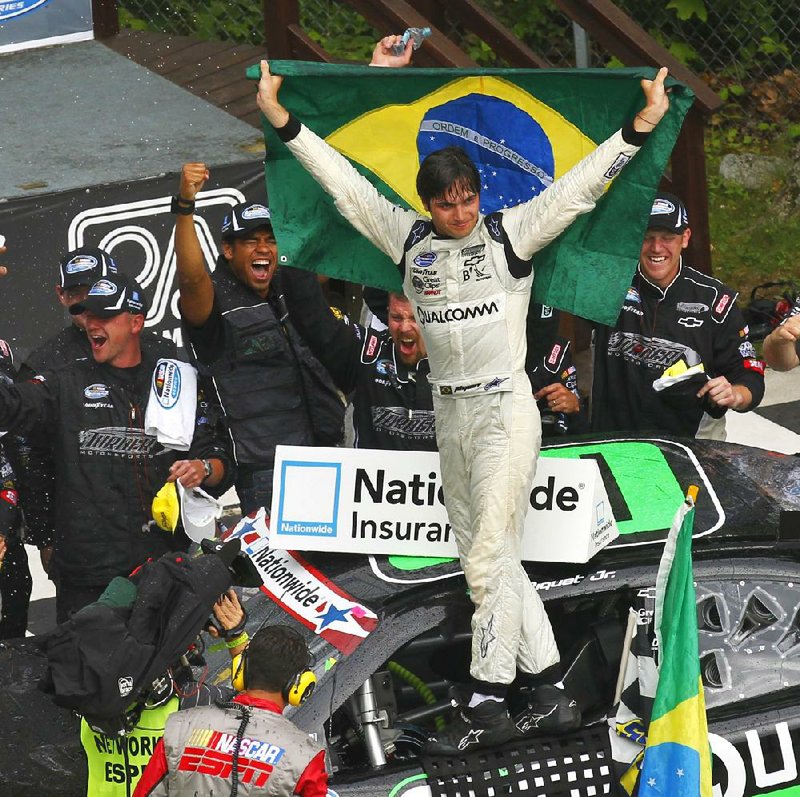 Nelson Piquet Jr. celebrates in victory lane after winning the NASCAR Nationwide Series Sargento 200 auto race at Road America in Elkhart Lake, Wis, Saturday, June, 23, 2012. (AP Photo/Jeffrey Phelps)