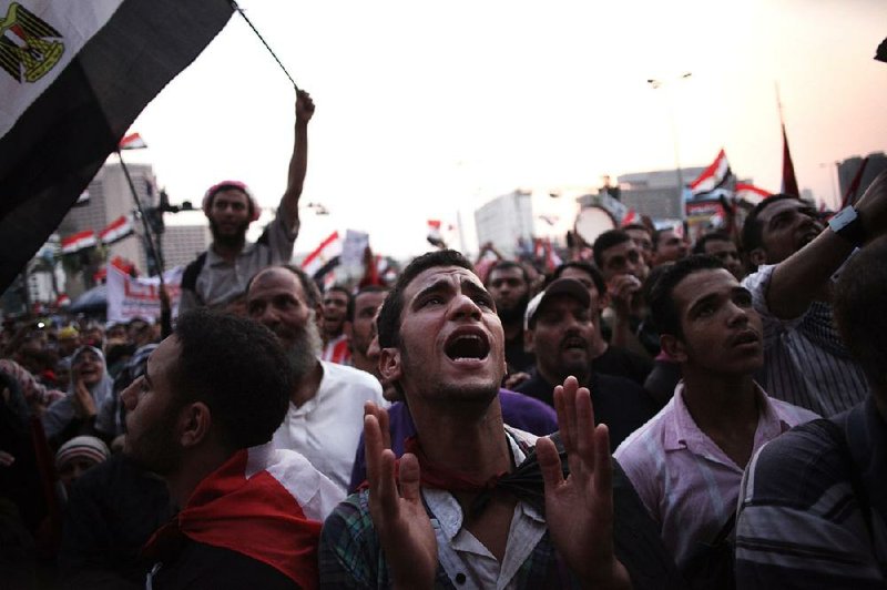 Protesters shout on Saturday in Cairo’s Tahrir Square, while Egyptians await the announcement of presidential runoff election results. 