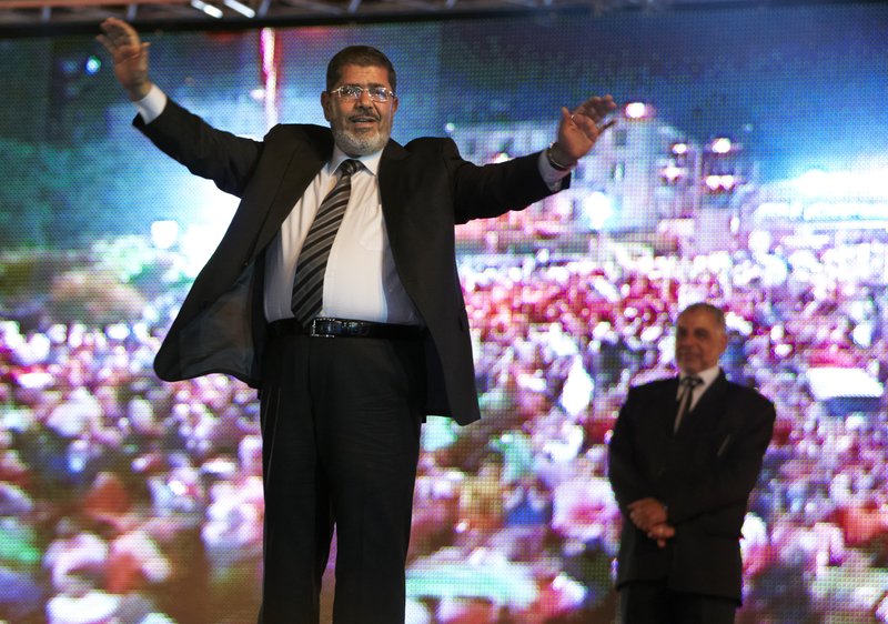 In this Sunday, May 20, 2012 file photo, the Muslim Brotherhood's presidential candidate Mohammed Morsi hold a rally in Cairo, Egypt. Egypt's electoral commission announced Sunday, June 24, 2012 that Morsi is victor of landmark presidential vote.