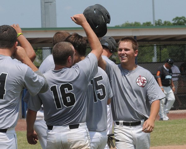 Andrew Hagel, right, is congratulated Saturday by Bentonville teammates, Ryan Harralston, left, and Kory Keithley after his grand slam home run in the American Legion baseball tournament against Texarkana. 