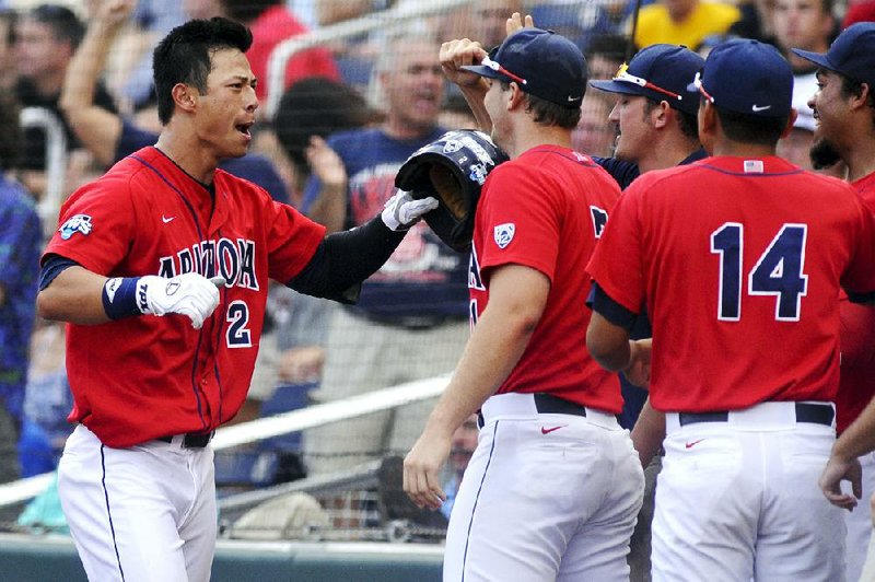 Arizona outfielder Robert Refsnyder (left) hit a two-run home run to lead the Wildcats to a 5-1 victory over South Carolina on Sunday at the first game of the College World Series Championship Series in Omaha, Neb. 