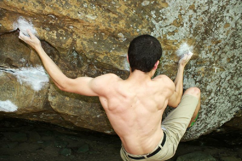 Patrick Small, 19, works the bouldering problem called My Space at a popular climbing area outside Cowell. 