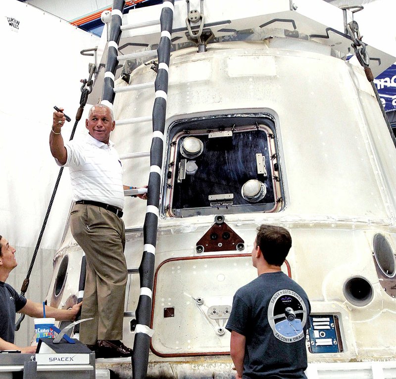 NASA Administrator Charles Bolden gets a close-up look at the SpaceX Dragon spacecraft earlier this month at the SpaceX facility in McGregor, Texas. 