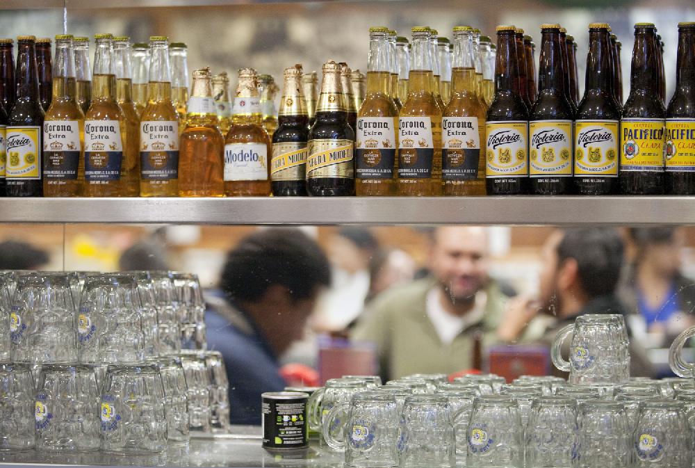 A selection of Grupo Modelo SAB brand beers including Modelo Especial, Negra Modelo, Corona, Victoria, and Pacifico sit on a shelf at a brew pub in Mexico City, Mexico on Tuesday, Dec. 28, 2010. Belgian brewer Anheuser-Busch InBev NV, the world's largest, inherited a 50 percent stake in Modelo plus nine of its 19 board seats in InBev's $52 billion acquisition of Anheuser-Busch in 2008. In gaining the Modelo stake held by the U.S. brewer, AB InBev also inherited long-running tensions between the partners. Photographer: Gustavo Graf/Bloomberg