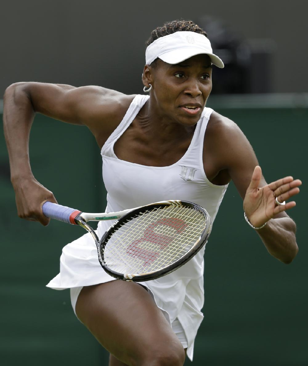 Venus Williams of the United States chases down a shot from Elena Vesnina of Russia during a first round women's singles match at the All England Lawn Tennis Championships at Wimbledon, England, Monday, June 25, 2012. (AP Photo/Alastair Grant)