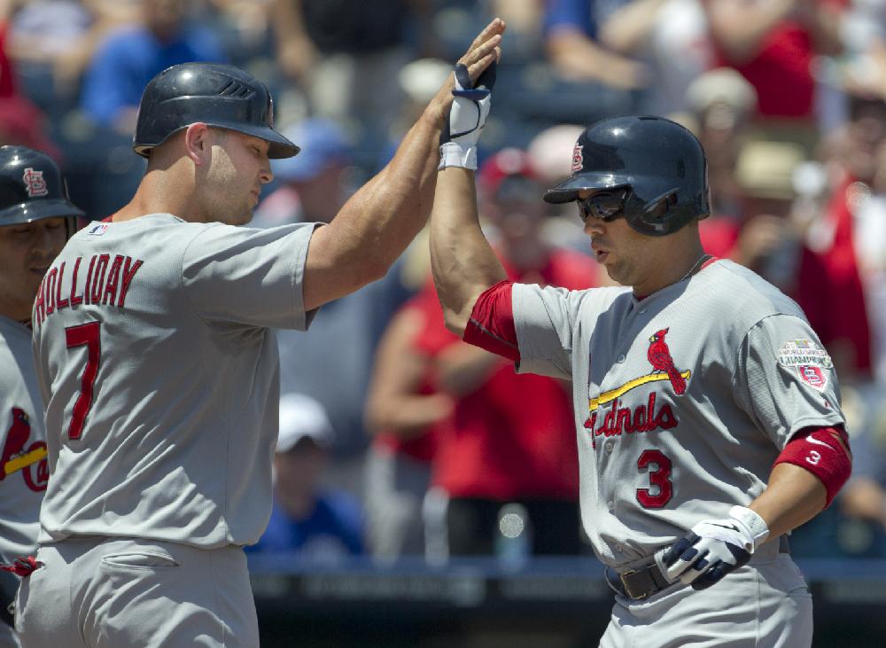 St. Louis Cardinals' Carlos Beltran (3) is congratulated by teammate Matt Holliday (7) after his three-run home run off Kansas City Royals starting pitcher Jonathan Sanchez during the first inning of a baseball game at Kauffman Stadium in Kansas City, Mo., Sunday, June 24, 2012. (AP Photo/Orlin Wagner)