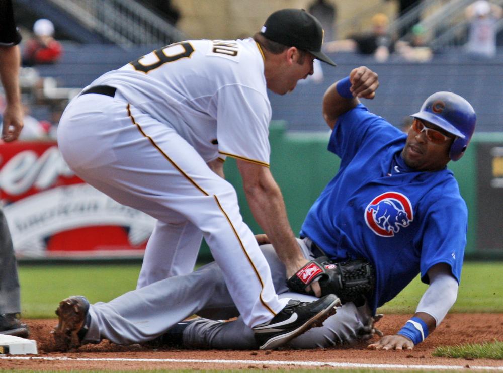 Pittsburgh Pirates pitcher Dana Eveland, left, takes out Chicago Cubs' Marlon Byrd at third base to end a second-inning rundown during a baseball game in Pittsburgh Monday, June 7, 2010. (AP Photo/Gene J. Puskar)
