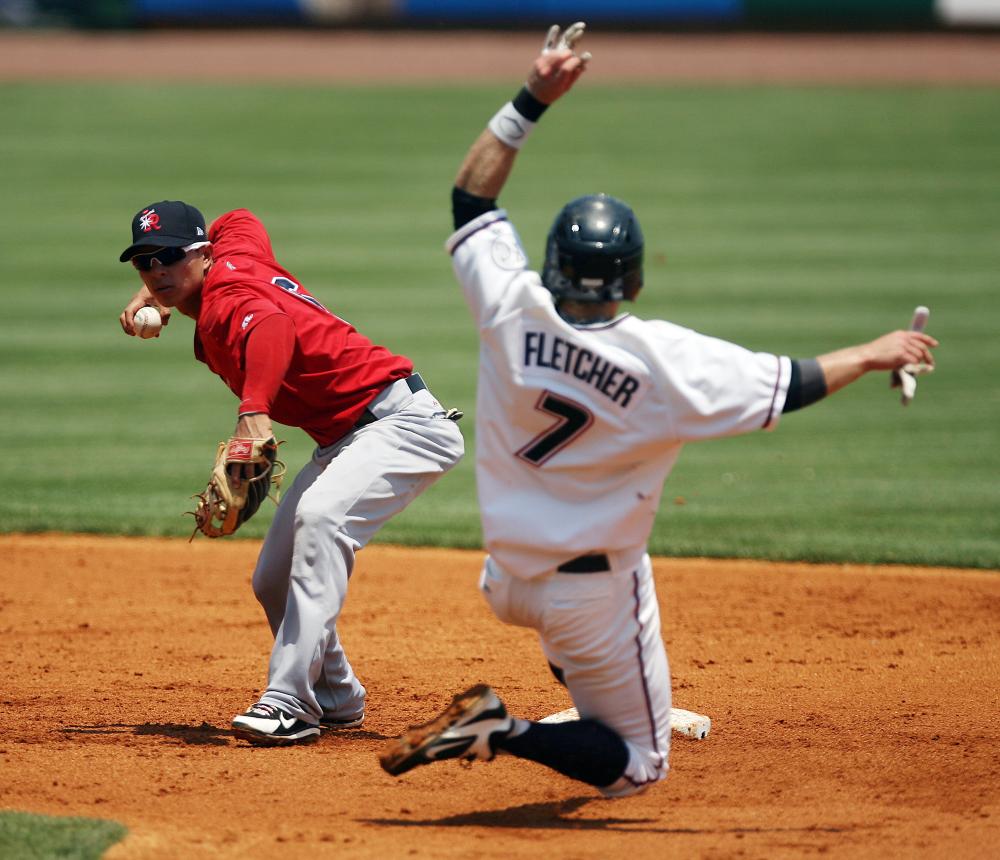 Arkansas Democrat-Gazette/WILLIAM MOORE
Travelers' shortstop Darwin Perez turns a double play over the Naturals' Brian Fletcher Monday, June 25, 2012 at Arvest Ballpark in Springdale.