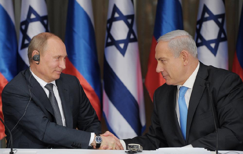 Russian President Vladimir Putin, left, shakes hands with Israeli Prime Minister Benjamin Netanyahu as they prepare to deliver joint statements after their meeting and a lunch in the Israeli leader's Jerusalem residence Monday, June 25, 2012. Netanyahu said Putin agrees that a nuclear Iran would pose a