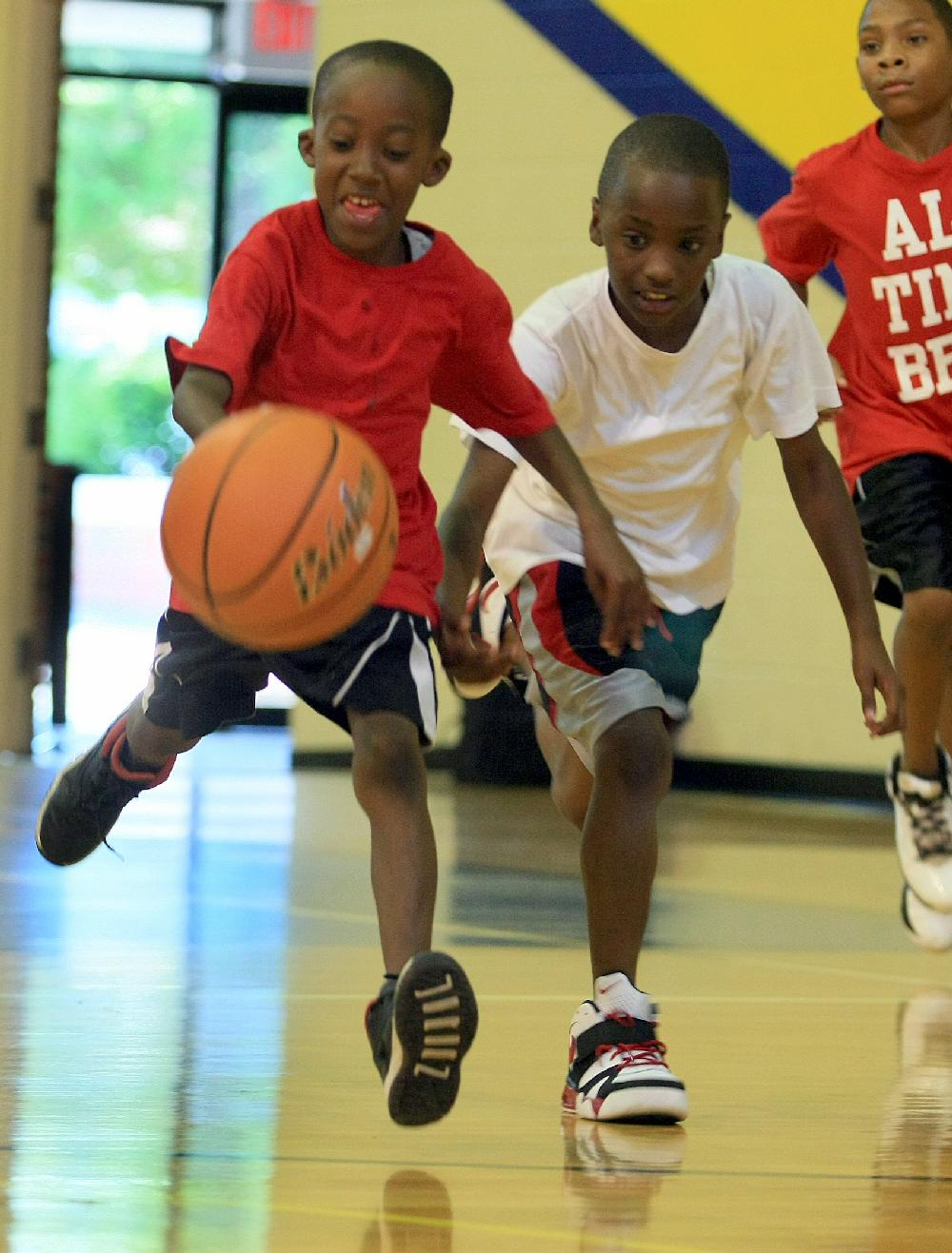 Arkansas Democrat-Gazette/RICK MCFARLAND --06/25/12-- Mark Green, 7, dribbles the ball as Jaylen Bozeman, 8, defends on him during the Hoop Dreams of Arkansas Youth Basketball Camp on the campus of the Arkansas School for the Death in Little Rock Monday.