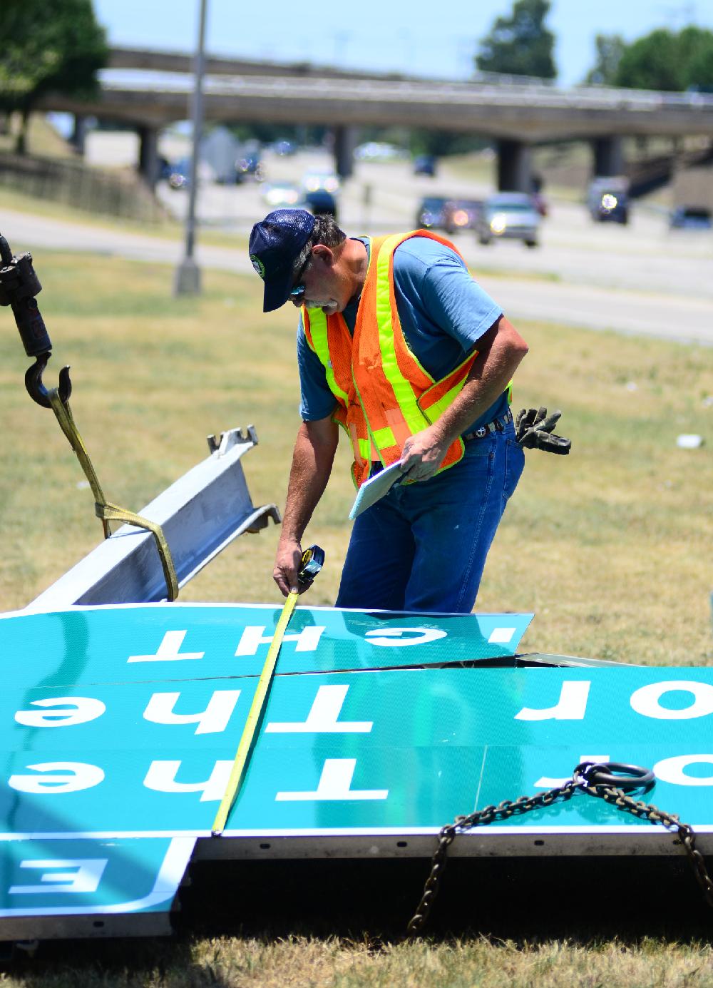 Arkansas Democrat-Gazette/  WILLIAM KENYON  06/25/12-- Highway Worker Michael Light on the 630 replaced a sign  by the Pine street  exit in the heat on Monday