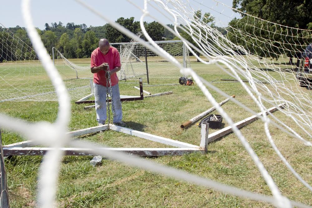 Arkansas Democrat Gazette/KAREN E. SEGRAVE -- 6/25/12--
Raymond Dixon works to disassemble a metal soccer goal before removing it from the soccer fields along Rebsamen Park Road on Monday afternoon.  The heavier, metal soccer goals were removed and replaced with lighter ones.