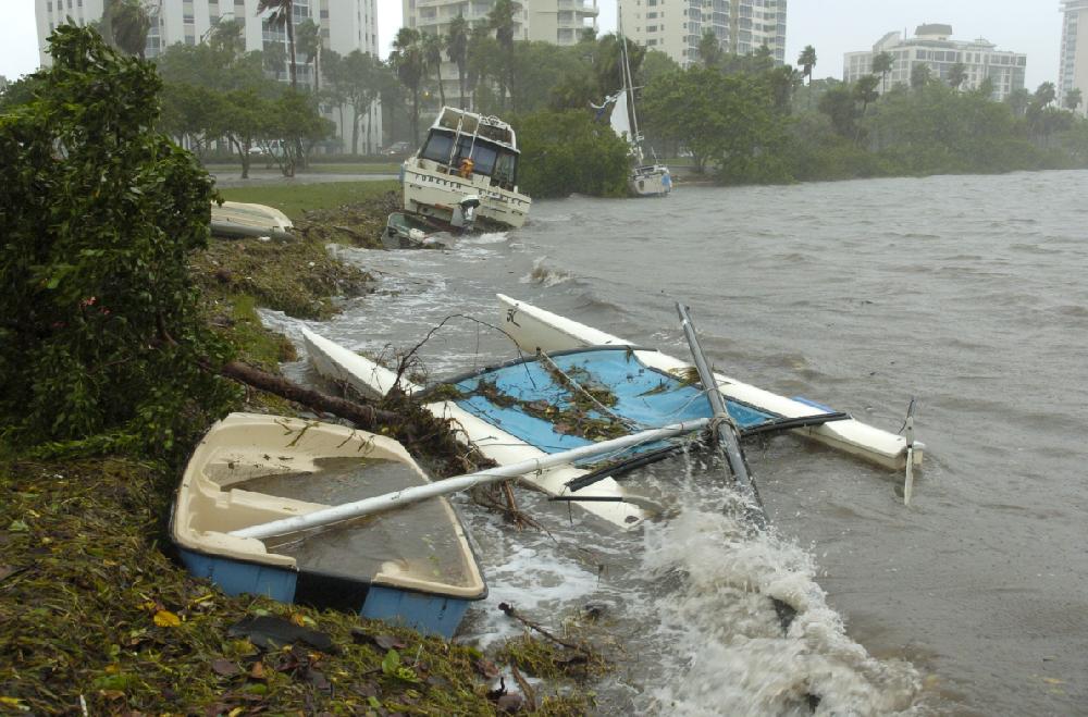 Two large boats and several dingys are were pushed onto shore at Bayfront Park after they broke loose from their moorings in downtown Sarasota, Fla. Monday, June 25, 2012. Tropical Storm Debby drenched Florida with heavy rains, flooded low-lying neighborhoods and knocked out power to thousands of homes and businesses as it lingered off the state's coast Monday. (AP Photo/Sarasota Herald-Tribune, Mike Lang) CHARLOTTE SUN OUT, BRADENTON HERALD OUT, MAGS OUT, TV OUT, INTERNET OUT, NO SALES