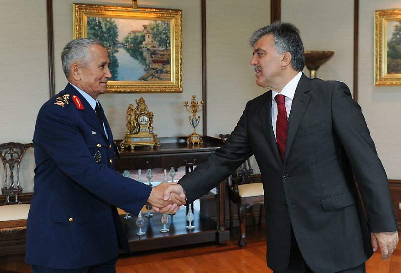 Turkish President Abdullah Gul (right) greets Gen. Mehmet Erten, commander of the Turkish air force, in Istanbul on Monday. Upon Turkey's request, NATO will hold a meeting today in Brussels concerning Friday's downing of a Turkish warplane by Syria.
