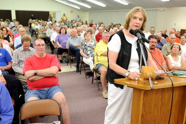 Patricia Haas speaks against a rezoning that would allow Walmart to build a Neighborhood Market at the intersection of U.S. 71 and Oldham Drive. Haas spoke Monday during a Bella Vista City Council meeting at the Community Church.