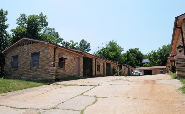 The Twin Arch Motel, 521 N. College Ave. in Fayetteville, has no visitors Monday. Rogers-based Community Development Partners have plans to convert the motel, built in 1950, into a nine-unit studio apartment community.