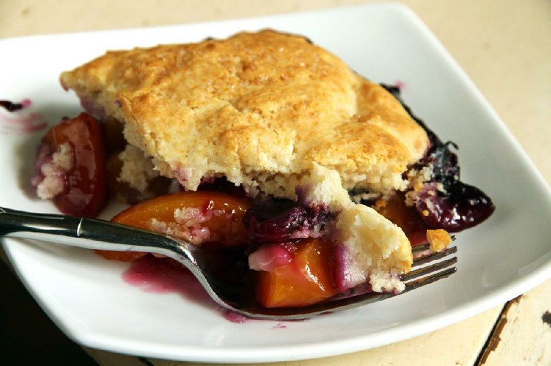 Peach-Blueberry-Cherry Cobbler, an American dessert, features summer fruits at their peak. 