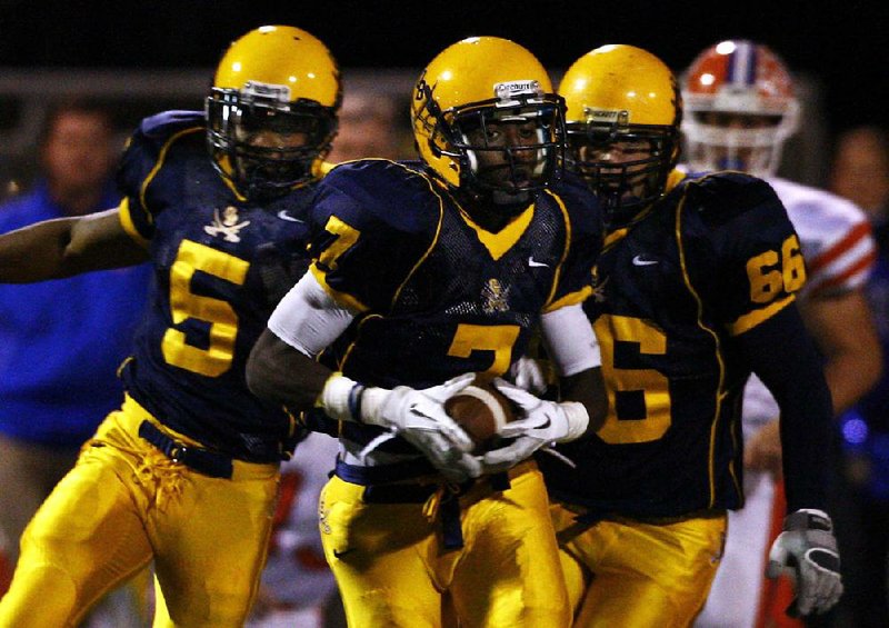 November 25, 2011 - Olive Branch senior WR D'Arthur Cowan (7) returns a first quarter punt for a TD against the Jaguars of Madison Central High School in the third round of MHSSAA Class 6A state playoffs.  Heading downfield with Cowan are OBHS senior LB Nick Johnson (5) and junior lineman Nick Hall (66).      (Stan Carroll/The Commercial Appeal)