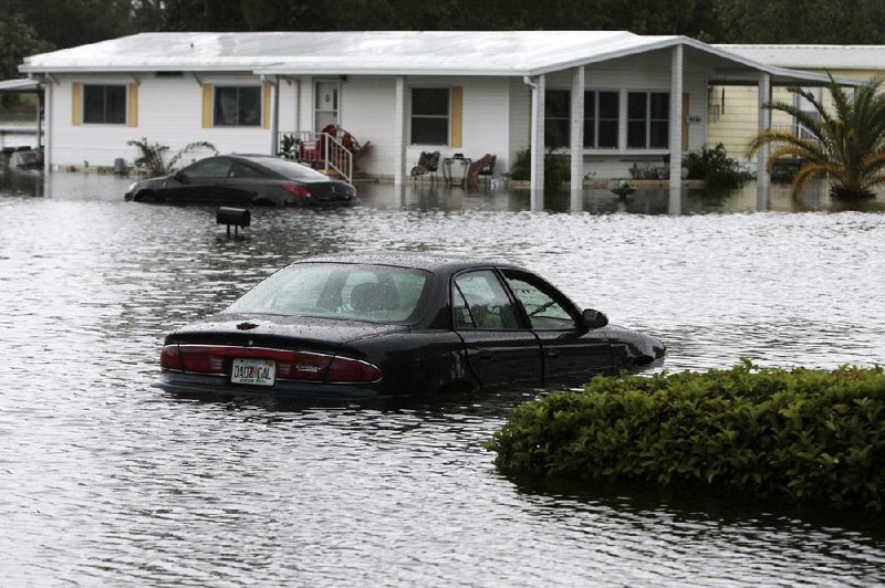 Several cars and homes remain under water in Brookridge, Fla. Tuesday, June 26, 2012. Tropical Storm Debby flooded homes, an animal shelter and closed parts of the main interstate highway across northern Florida on as the storm crept closer to the state, dropping more than two feet of rain in one sparsely populated area. (AP Photo/The Tampa Bay Times, Will Vragovic)  