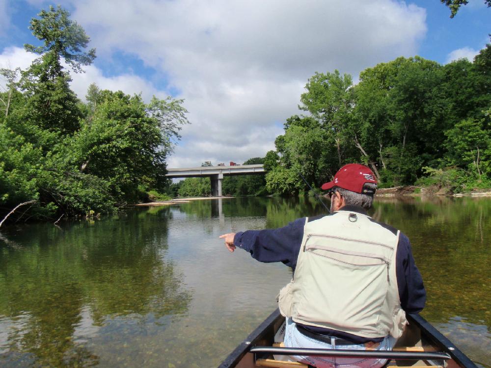 Tonkinson points to a cruising smallmouth bass during the approach to the U.S. 71 bridge.