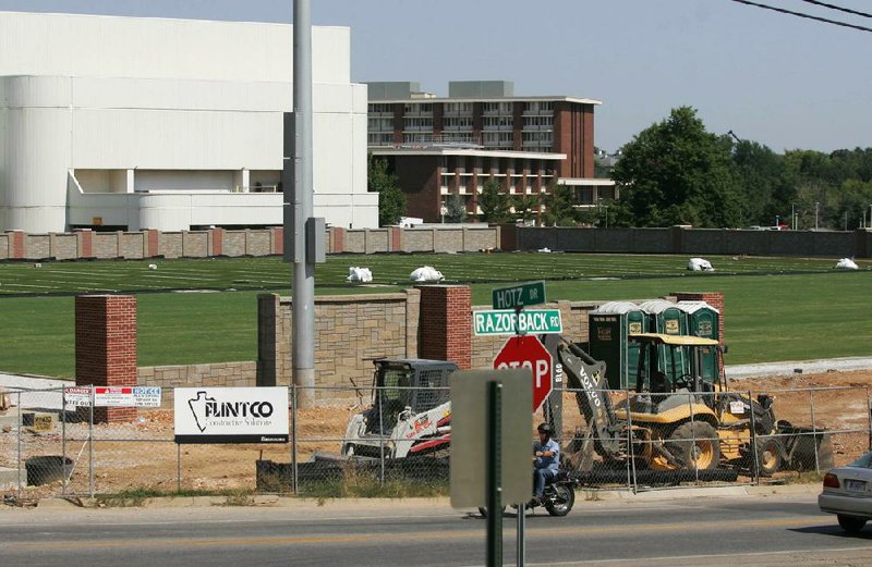 Work continues Wednesday on the new Razorbacks football practice field south of Walker Pavilion on the University of Arkansas at Fayetteville campus. A 39-year-old man was working on the UA Football Operations Center before being rushed to the hospital where he died after overheating.